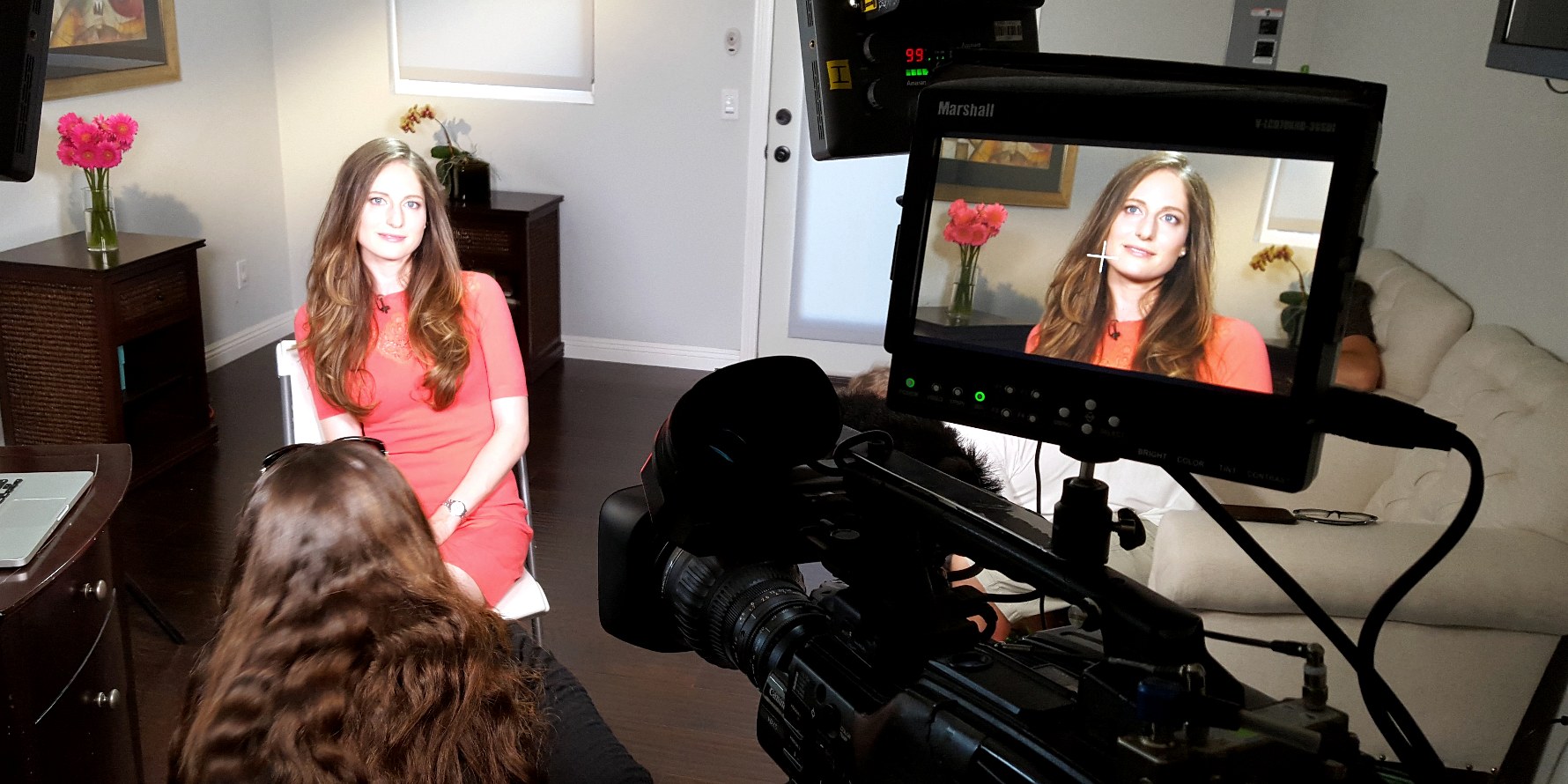 Dr. Rachel Malamed being interviewed on camera, framed in the monitor of a television crew's setup